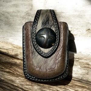 Western Style Leather And Cowhide Cell Phone Case With A Cross Embellishment.